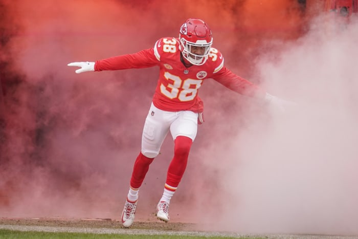 L’Jarius Sneed runs out of smoke with his arms out to the side